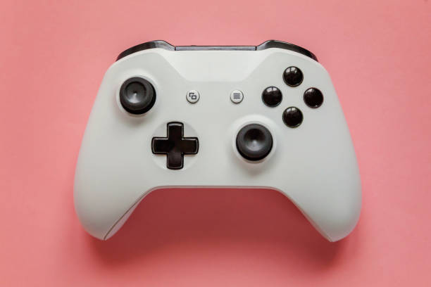 istock White joystick on pink background. Computer gaming competition videogame control confrontation concept 1148701649