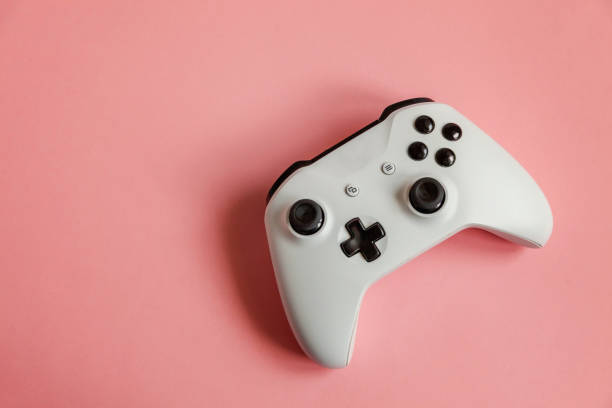 istock White joystick on pink background. Computer gaming competition videogame control confrontation concept 1148701693