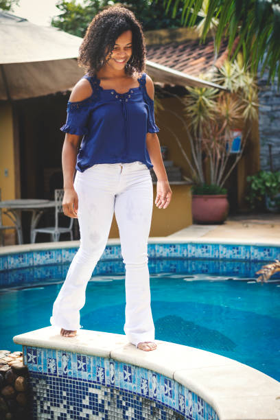 istock Beautiful woman near a pool, walking. 1148703515