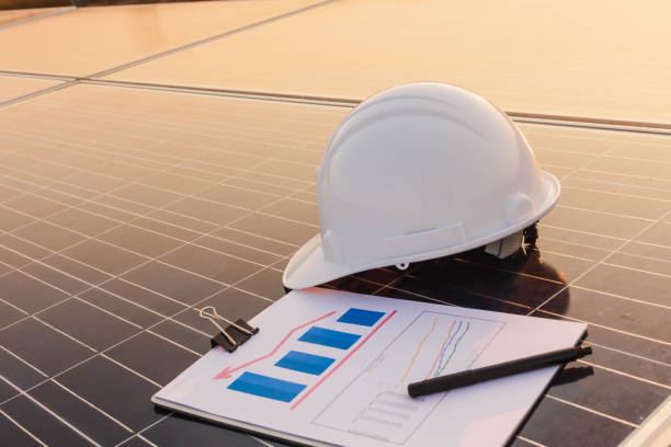 istock Engineers are examining the performance graph of energy production from solar panels that are alternative energy and which is the concept of sustainable resources 1148704949
