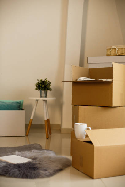 istock Bunch of cardboard boxes stacked in new house 1148714328