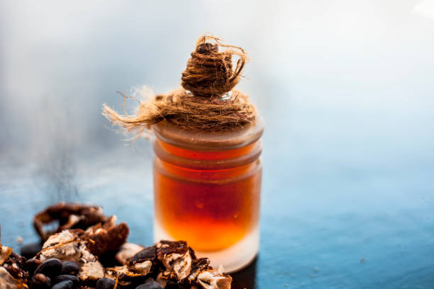 istock Tamarind or imli or amli in a clay bowl along with its roasted seeds and extract essential oil in a glass bottle on wooden surface. 1148714412