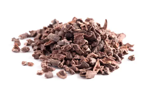 Photo of A Pile of Raw Chocolate Nibs on a White Background