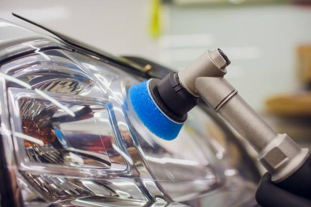 istock auto mechanic buffing and polishing car headlight 1148714737