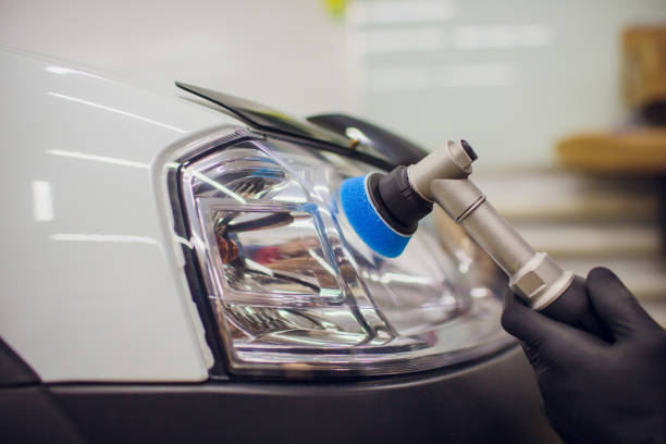 istock auto mechanic buffing and polishing car headlight 1148714750