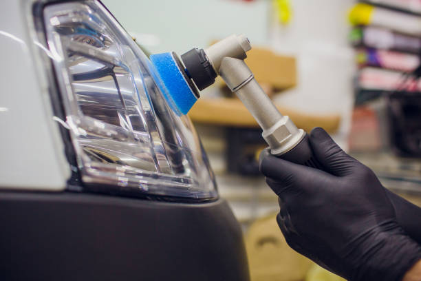 istock auto mechanic buffing and polishing car headlight 1148714755