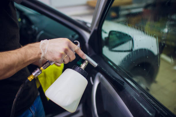 istock Handsome man cleaning car with hot steam 1148715507