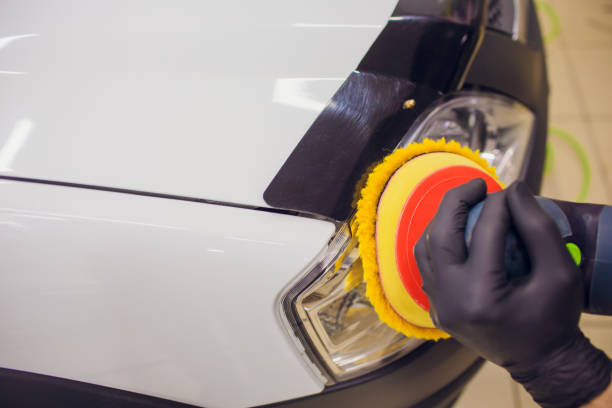 istock auto mechanic buffing and polishing car headlight 1148715557