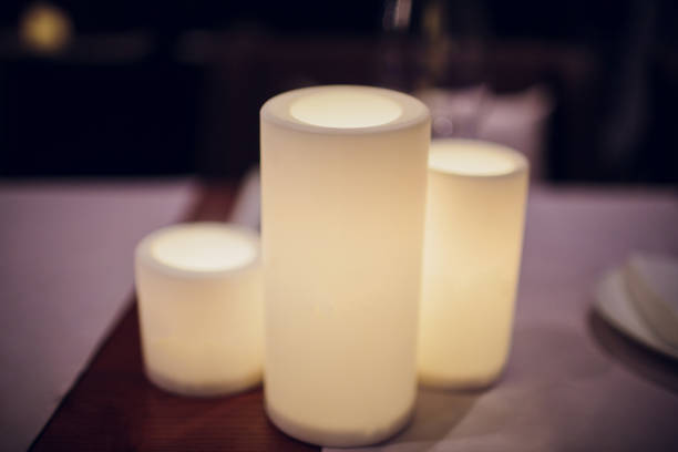 istock Electric candle on the dinner table Night. Blur background, Focus selected 1148715855