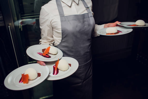istock Waiters carrying plates with meat dish at a wedding 1148716417
