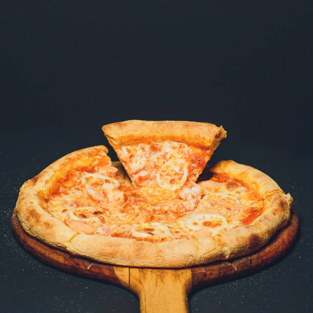 istock Pizza pepperoni, oregano on a black background 1148717597