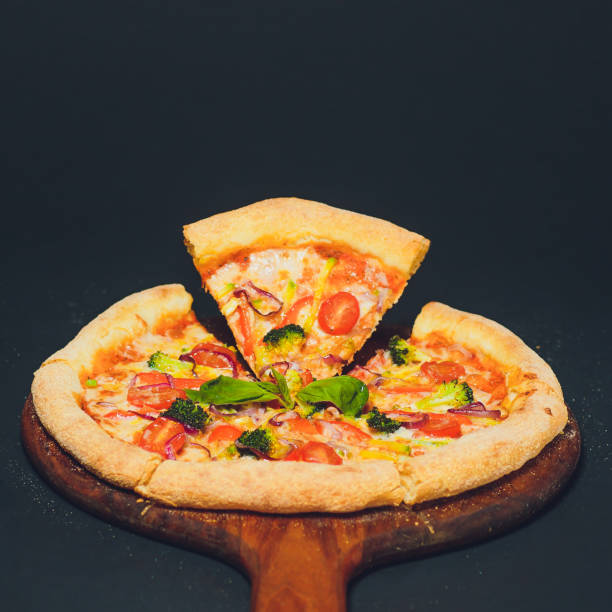 istock Pizza pepperoni, oregano on a black background 1148717604