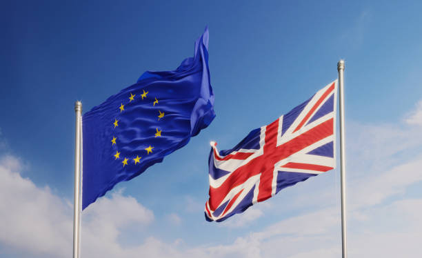 istock European Union and British Flags Waving at Different Directions  Over Blue Sky 1148718804