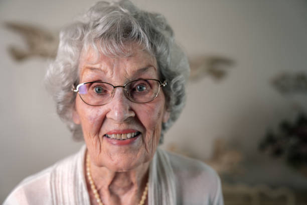A Smiling, Confident 100-Year Old Woman in Her Home 100-Year Old Woman smiling cheerfully and confidently, in Her Home over 100 stock pictures, royalty-free photos & images