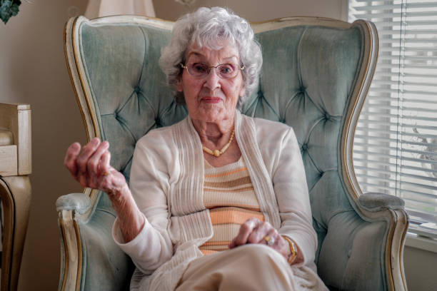 100-year old woman having a cheerful conversation in her home - 80 year old imagens e fotografias de stock