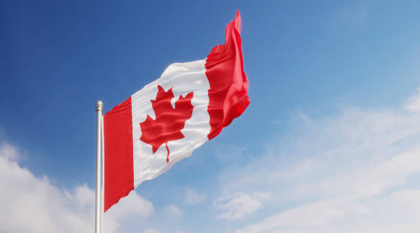 istock Canadian Flag Waving With Wind Over Blue Sky 1148721058
