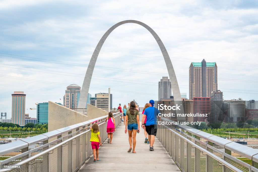 visiting St Louis Gateway Arch overlook St Louis, MO - July 28, 2018: Family is walking to the overlook of the Gateway Arch and St Louis skyline on the opposite shore of the Mississippi River. Mississippi River Stock Photo