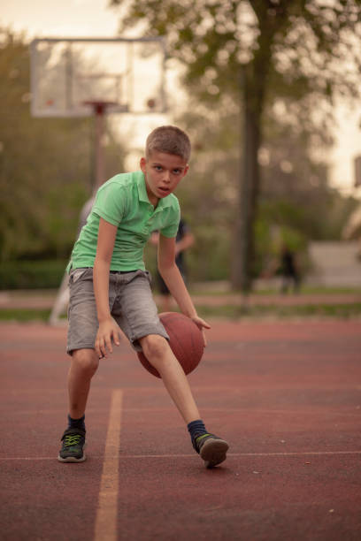 istock One boy, exercising dribbling ball between his legs. 1148726861