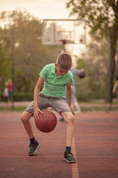istock One boy, exercising dribbling ball between his legs. 1148727411