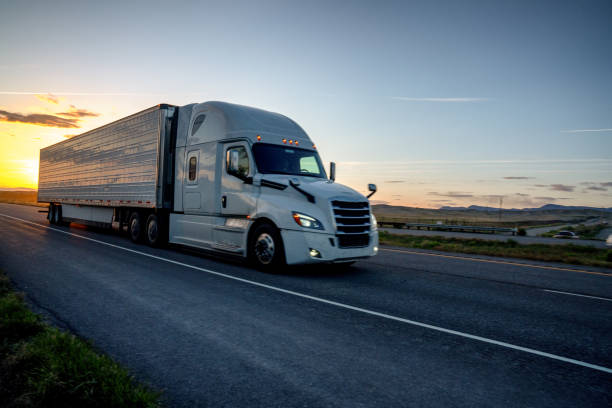 istock Long Haul Semi Truck on a Highway at Dusk under a Dramatic Sky 1148727736
