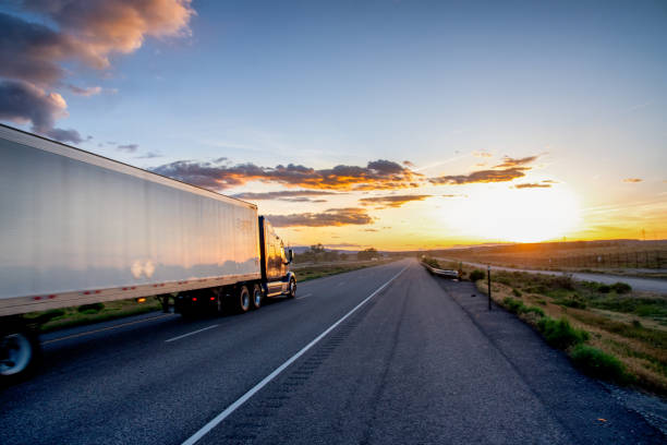 istock Long Haul Semi Truck on a Highway at Dusk under a Dramatic Sky 1148727737