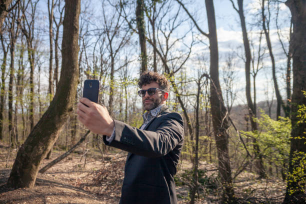 istock one young handsome man, talking a selfie outdoors in nature. 1148730845