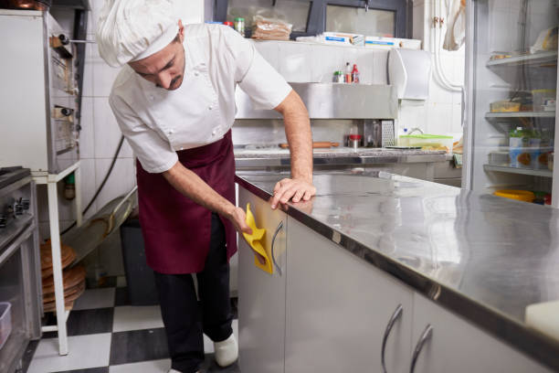 istock young chef in kitchen cleaning cabinets, after closing restaurant. 1148731723