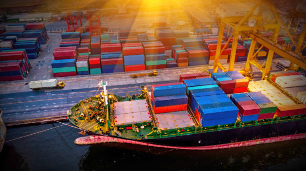 istock Logistics and transportation of Container Cargo ship and Cargo plane with working crane bridge in shipyard at sunrise, logistic import export and transport industry background 1148731994
