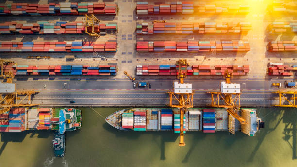 istock Logistics and transportation of Container Cargo ship and Cargo plane with working crane bridge in shipyard at sunrise, logistic import export and transport industry background 1148732007