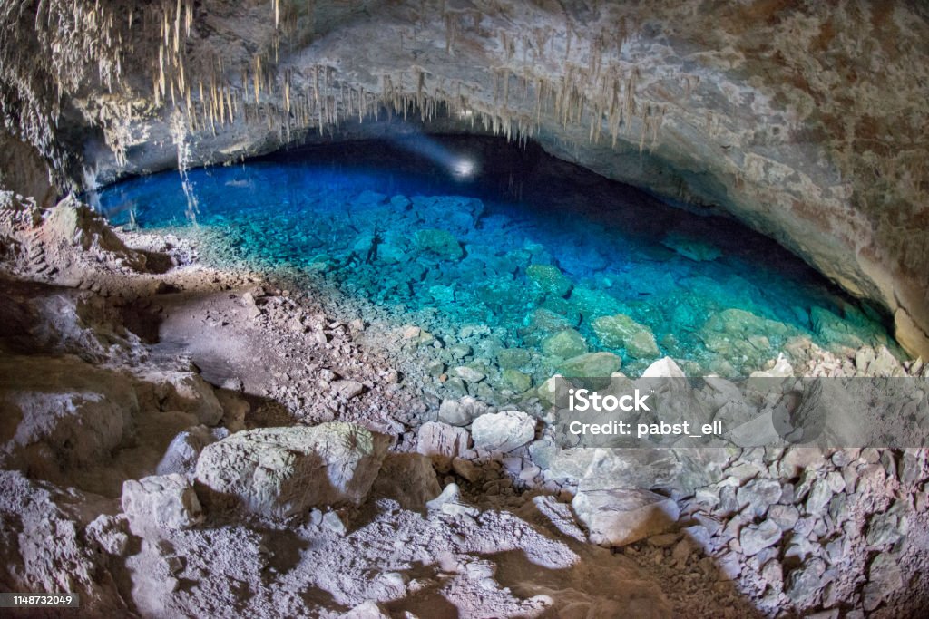 Blue lake grotto Natural Monument in Bonito Gruta do Lago Azul natural monument in Bonito, Mato Grosso do Sul. Cave with water on a blue lake illuminated with a flashlight. Mato Grosso do Sul State Stock Photo