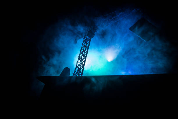 istock Abstract Industrial background with construction crane silhouette over amazing sunset sky. Tower crane against the evening sky. Industrial skyline 1148732815