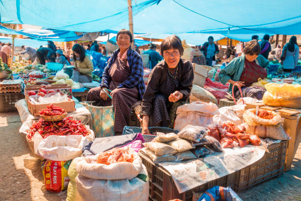 People shopping for produce at the Paro weekend market Paro's weekend market isn't very large but it has a traditional feel it is busiest on Sunday mornings bhutan stock pictures, royalty-free photos & images