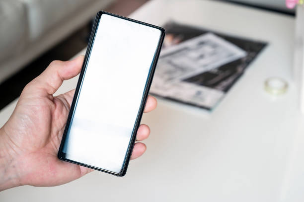 istock Closeup man hand holding smartphone with blank screen, copy space for text or product display. 1148738534