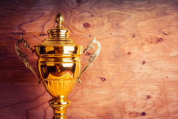 istock Gold trophy against the wooden background 1148738808
