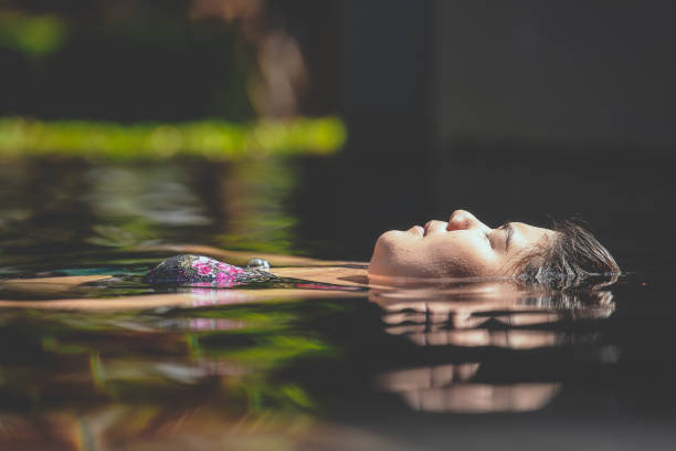 istock Fat woman relaxing in swimming pool. 1148746965