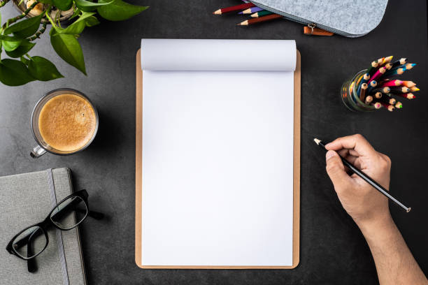 istock white paper with clipboard on black background 1148749629