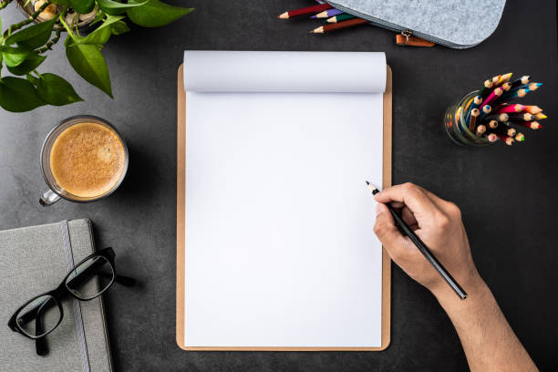 istock white paper with clipboard on black background 1148749632