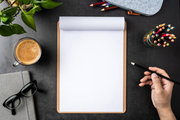 istock white paper with clipboard on black background 1148749636