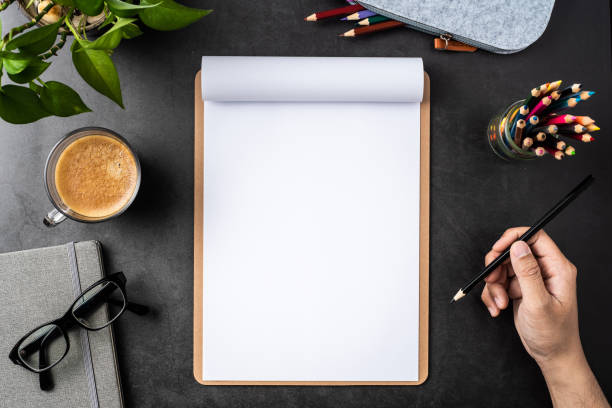 istock white paper with clipboard on black background 1148749639