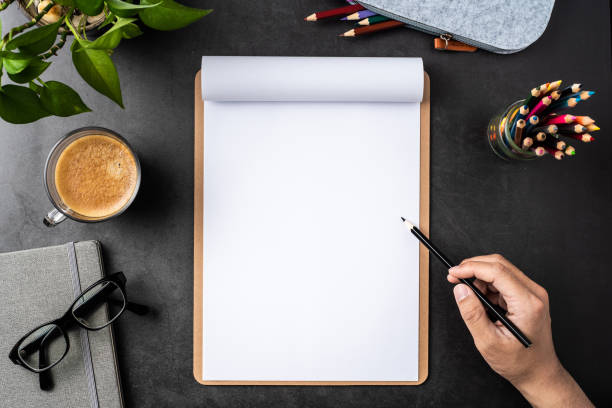istock white paper with clipboard on black background 1148749642