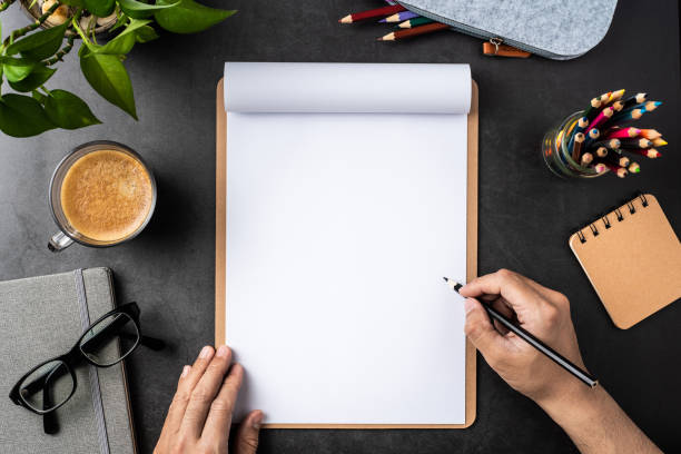 istock white paper with clipboard on black background 1148749646