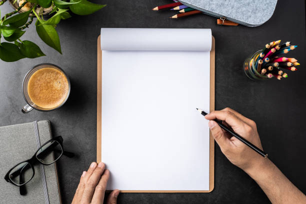 istock white paper with clipboard on black background 1148749651