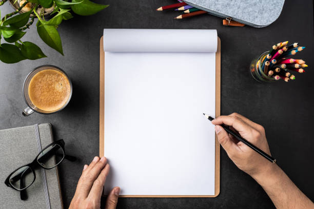 istock white paper with clipboard on black background 1148749653