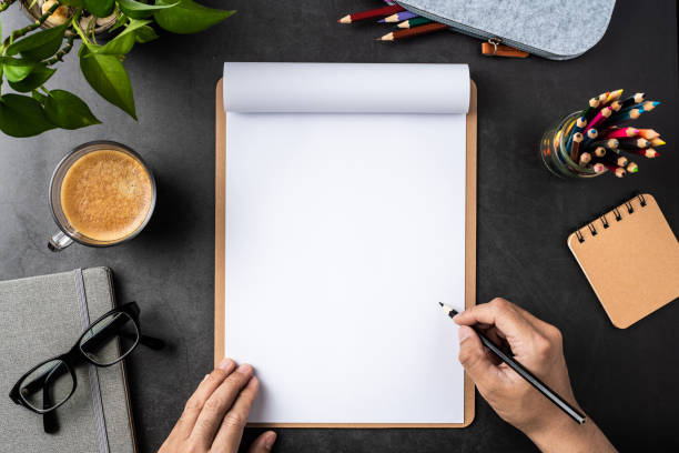 istock white paper with clipboard on black background 1148749662
