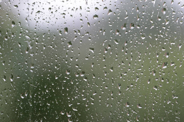 istock Raindrops on window glass during the rain close up. Natural background 1148749922