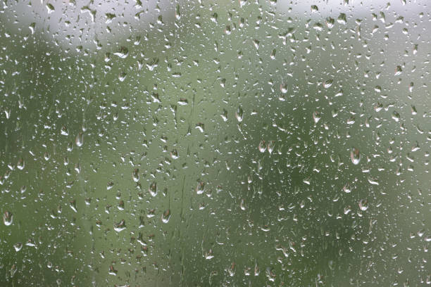 istock Raindrops on window glass during the rain close up. Natural background 1148749928