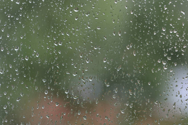 istock Raindrops on window glass during the rain close up. Natural background 1148749936