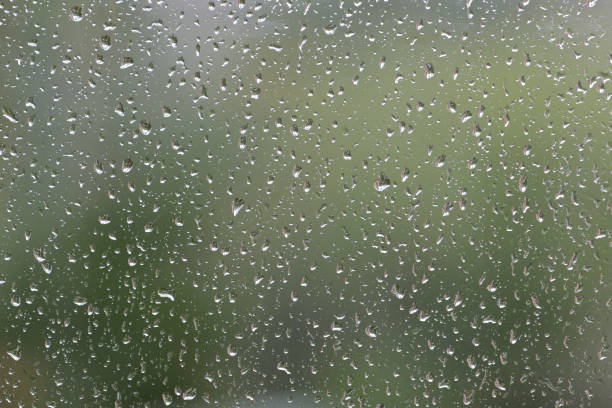 istock Raindrops on window glass during the rain close up. Natural background 1148751034