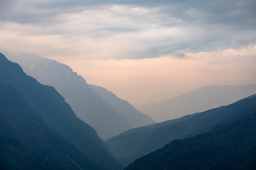 Sky and mountain ridges of a Himalayan valley seen from Gasa in Bhutan