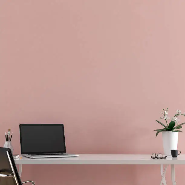 Workdesk with decoration on hardwood floor in front of empt pink wall with copy space. 3D rendered image.